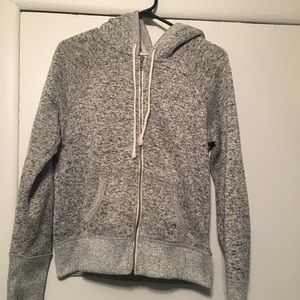 Gray zip up jacket.